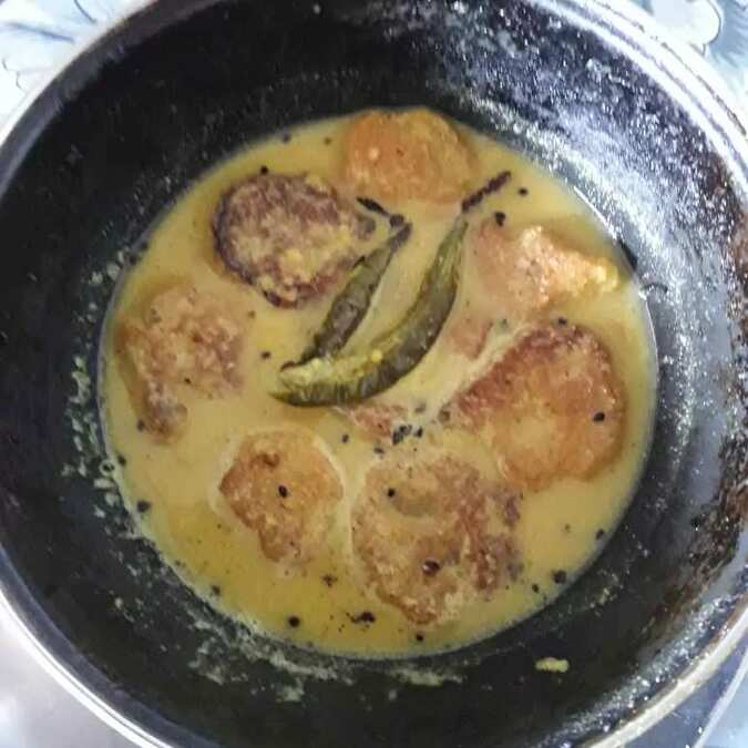 Masoor dal r bora r jhal/red lintil fritter's in mustard sauce